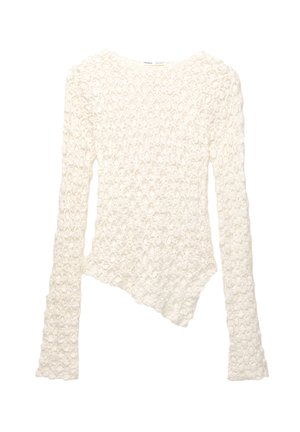 Weißer langärmeliger Strickpullover mit floralem Muster und asymmetrischem Saum.