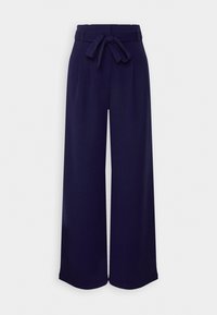 Pantalon large bleu marine avec taille haute et ceinture en tissu nouée en nœud devant, présenté sur fond blanc.