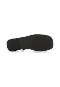 Black rubber shoe sole with a textured grip pattern, featuring a rounded shape and smooth edges. Slightly curved at the heel area.
