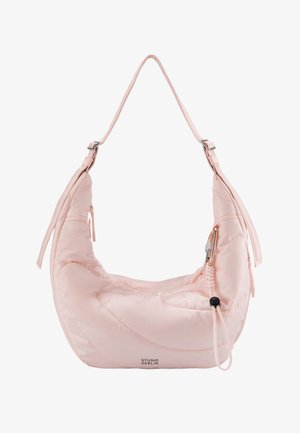 Soft pink crescent-shaped shoulder bag with adjustable straps, zipper pocket, elastic cord, and "Studio Berlin" logo on front bottom.
