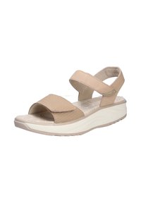 Sandalia beige con dos correas anchas, plantilla texturizada y soporte para el arco. Presenta una suela blanca acolchada con un pequeño tacón.
