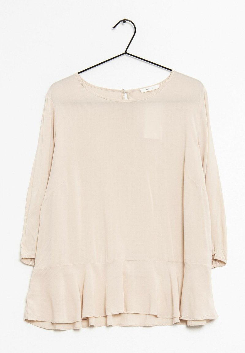 Blusa lunga a maniche con scollo rotondo, colore beige chiaro, orlo peplo e dettaglio a botte sul retro. Realizzata in un tessuto morbido e fluido.