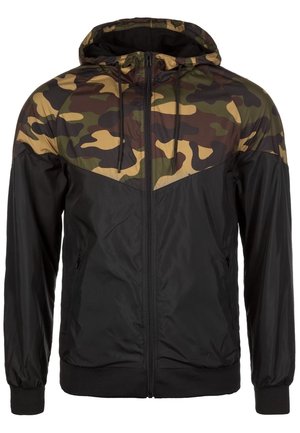Men’s full-zip hooded jacket with black fabric and camo-patterned upper chest, shoulders, and hood, featuring zippered side pockets.