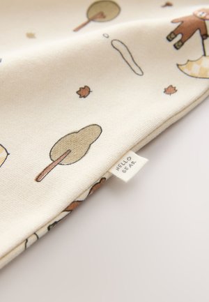 Cotton fabric featuring a light cream background with playful patterns of trees, leaves, and a bear holding an umbrella, labeled "HELLO BEAR."