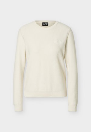 Κρεμ χρωματιστό πλεκτό πουλόβερ με μακριά μανίκια, στρογγυλό ντεκολτέ και ανάγλυφο λογότυπο EA7 στο πάνω αριστερό μέρος του στήθους.