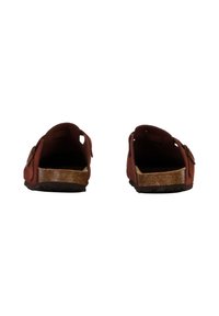 Brun sandal med korksål, åbent design, justerbar spænde og en struktureret overflade. Har åbne sider til ventilation.