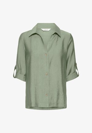 Vihreä lyhythihainen paita, joka on valmistettu tekstuurilla varustetusta kankaasta. Paidassa on napit edessä, kaulus ja hihansuissa kääntöosat.