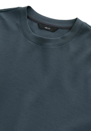 Dark teal crew neck sweatshirt made of soft fabric, featuring a simple design with a smooth texture and no visible patterns or accents.