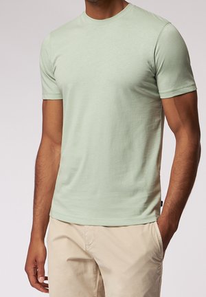 Lys grøn kortærmet t-shirt lavet af blød bomuld, med rund halsudskæring og sømløse skuldre. Diskret tekstur overalt.