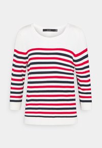 Raidallinen neulepaita, jossa on vaakasuoria raitoja punaisena, laivastonsinisenä ja valkoisena. Pidennetyt hihat, jotka ulottuvat kolme neljännestä, ja pyöreä kaula-aukko. Suuri sileä rakenne.