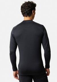 Sportshirt met lange mouwen in effen zwart, gemaakt van rekbaar, soepel materiaal. Heeft een ronde kraag en een aansluitende pasvorm.