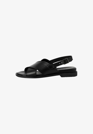 Sandalo in pelle nera con cinturini incrociati, design con punta aperta, fibbia regolabile e suola piatta in gomma. Design minimalista ed elegante.