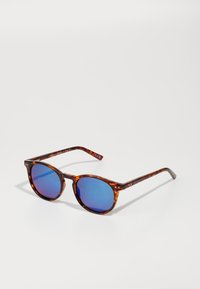 Tortoiseshell sunglasses with round frames, blue mirrored lenses, and patterned arms. Features subtle hardware accents at the temple.