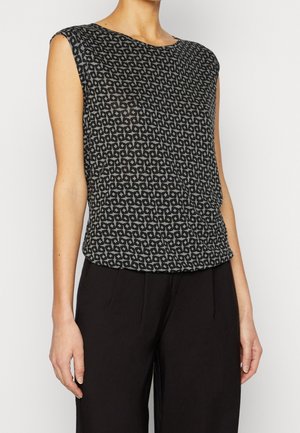 Mouwloos topje in zwart met een gestructureerd patroon van ineengrijpende vormen. Lichtgewicht stof met een ontspannen pasvorm, gecombineerd met donkere broek.