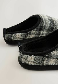 Fuzzy black and gray slippers with a soft textured upper, black fleece lining, and a sturdy rubber sole. Features back tabs for easy wear.