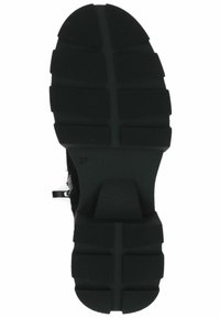 Suela de zapato de goma negra con surcos profundos, superficie texturizada y sección de talón moldeada. Tamaño marcado como 37 en la parte inferior.