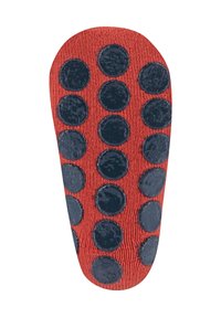 Textured red slipper sole featuring navy blue circular rubber dots for grip. Smooth edges and a contoured shape for foot fit.