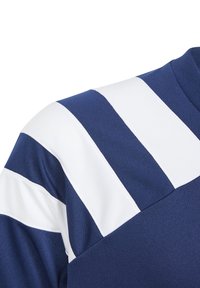 Sudadera de color azul marino con rayas diagonales blancas en el hombro. El material parece texturizado y ligeramente elástico, con un cuello redondo.