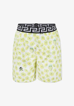 Costumi da bagno da uomo con una base bianca decorata da motivi floreali gialli, fragole verdi e accessori neri su una cintura elastica.