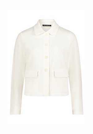 Veste blanche texturée à manches longues avec col, quatre boutons sur le devant et deux poches à rabat à la taille.