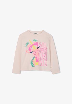 Light pink long-sleeve shirt featuring a colorful graphic of a giraffe in headphones, with bold text "ALL LIGHTS ON ME" in neon colors.