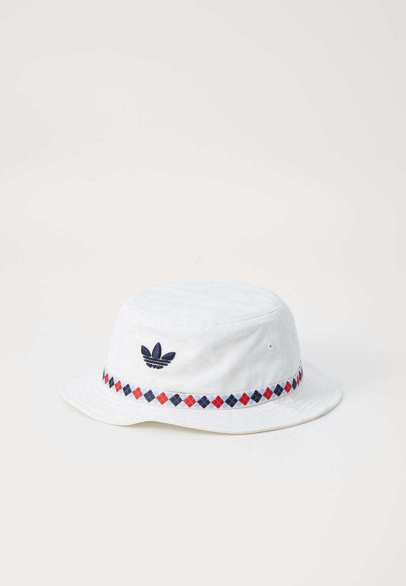 White bucket hat made of cotton with a navy blue embroidered logo. Features a patterned band in red, navy, and light blue around the brim.