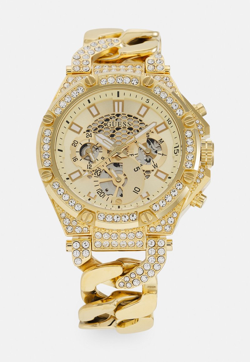 Montre bracelet en or avec une lunette texturée, trois sous-cadrans et un bracelet chunky en maillons, ornée de cristaux transparents et d'un cadran de couleur claire.