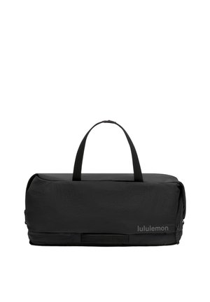 Sac de sport rectangulaire noir avec deux poignées et un compartiment zippé, avec le nom de la marque "lululemon" en bas à droite.