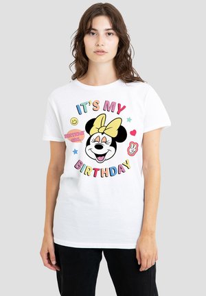 White cotton t-shirt featuring a colorful graphic of a smiling character with a yellow bow, text "IT'S MY BIRTHDAY," and decorative elements.