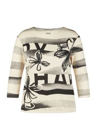Cremfarbene Bluse mit Dreiviertelärmel, versehen mit schwarzen Blumenmustern und kräftigen Streifenmustern. Weicher Stoff mit lockerer Passform.
