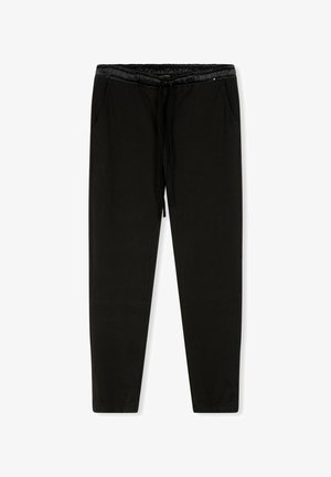 Schwarze Jogginghosen aus weichem Stoff, mit einem Kordelzugbund, elastischen Bündchen an den Knöcheln und zwei seitlichen Taschen. Glatte Textur überall.