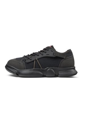 Black athletic shoe featuring mesh panels, textured suede accents, a cushioned sole, and dark laces, designed for comfort and breathability.