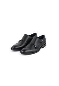 Czarne skórzane buty z okrągłym noskiem, podwójnymi paskami z klamrami oraz niskim obcasem, charakteryzujące się gładką teksturą i eleganckim wyglądem.