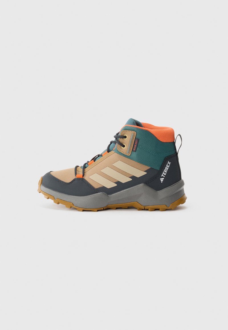Lightweight hiking boot featuring a beige, blue, and orange color scheme, textured fabric, rubber sole, and prominent three-stripe design.