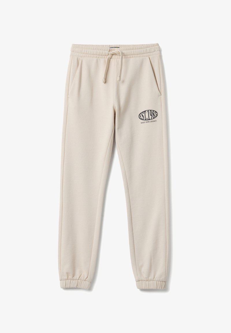 Pantalon de survêtement beige clair avec taille élastique et cordon de serrage. Comprend deux poches latérales et un logo imprimé sur la cuisse gauche.