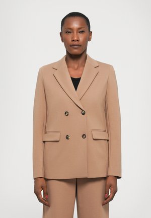 Blazer beige doppiopetto realizzato in tessuto liscio, con colletto a scollo, due tasche frontali e grandi bottoni rotondi.