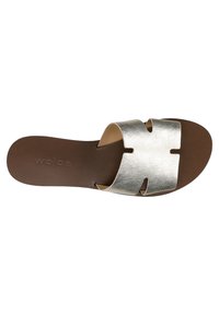 Sandalo slip-on in argento metallico con un design a taglio sulla suola marrone scuro, caratterizzato da una superficie in pelle liscia e accenti minimali.