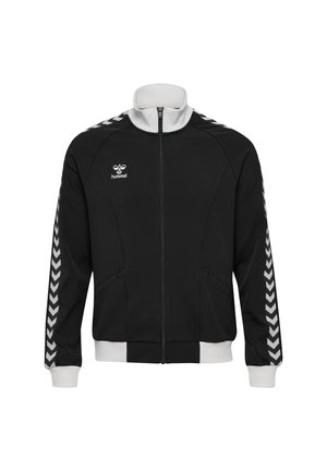 Czarna sportowa kurtka na zamek z białymi paskami w kształcie jodełki na rękawach, białym kołnierzem i mankietami oraz małym logo "hummel" na piersi.