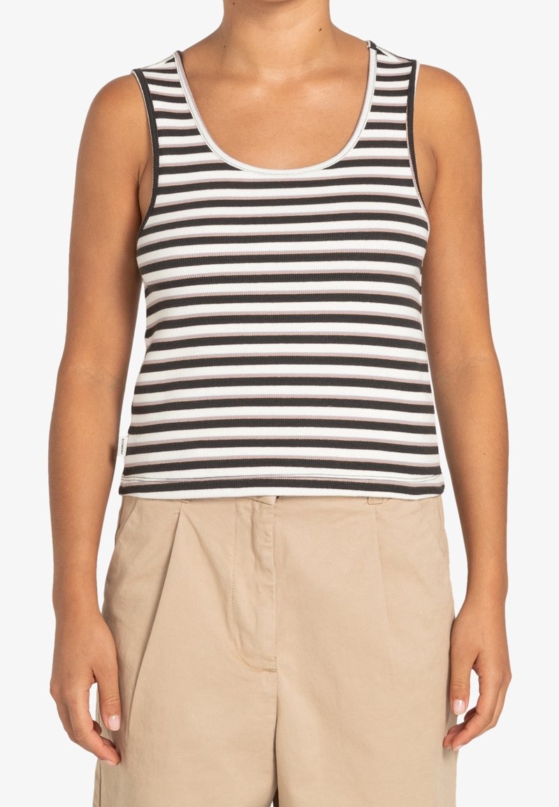Černobíle pruhovaný tílko s žebrovanou texturou, s výstřihem do kulata a ramínky. V kombinaci s béžovými kalhotami s vysokým pasem.