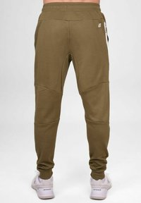 Olivgrüne Jogginghosen aus weichem Stoff, mit einem taillierten Bein Design, elastischem Bund und unauffälligen Seitentaschen.