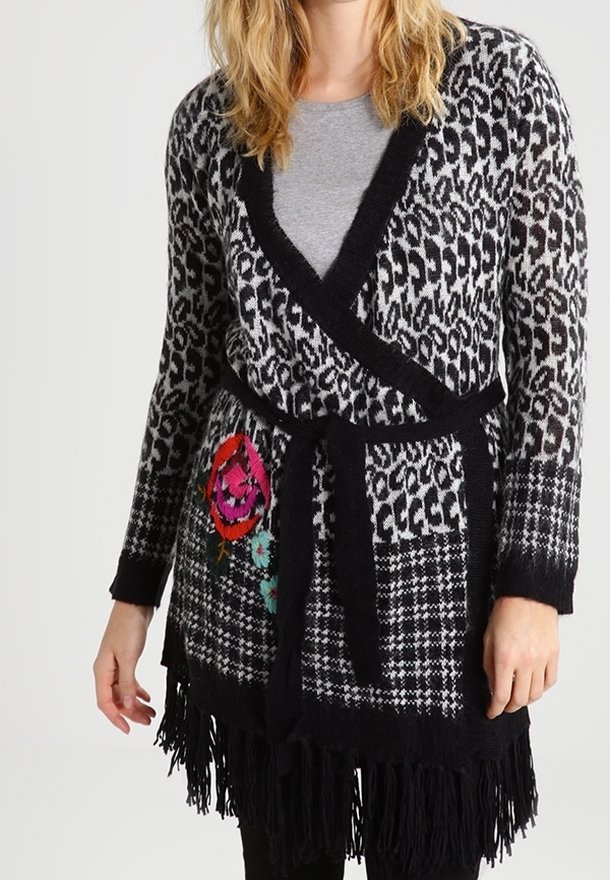 Black and gray patterned cardigan with a wrap design, featuring fringed hem, floral embroidery, and long sleeves. Soft texture, belted waist.