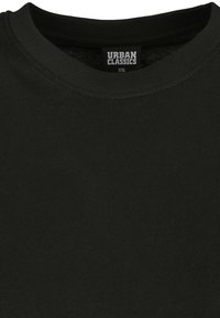 Tricou negru din bumbac cu decolteu rotund și etichetă "Urban Classics" mărimea XS în interiorul gulerului.