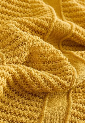 Yellow knitted fabric with a textured, open pattern and smooth sections. The material appears soft and lightweight with visible stitches.