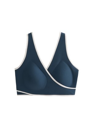 Laivaston sininen rintaliivi valkoisilla yksityiskohdilla, joissa on saumatön muotoilu ja muotoutuvat kupit. Kangas on sileä ja joustava, tarjoten mukautuvan istuvuuden.