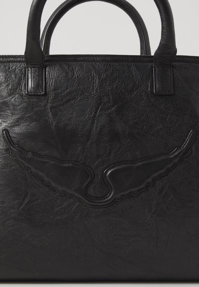 Black leather tote bag featuring a textured finish, curved wing design embossed on the front, and sturdy double handles.