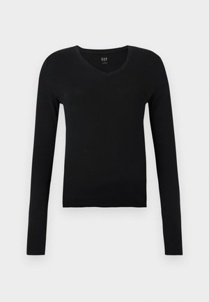 Haut noir à manches longues en V, fabriqué en coton doux, avec une coupe ajustée et un design minimaliste sans motifs ni accents supplémentaires.