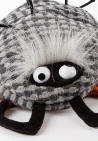 Black and gray plush spider with large white eyes, fuzzy white hair on top, and textured body design. Features black felt legs and orange accents.