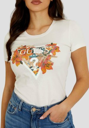T-shirt en coton blanc avec un col rond et des manches courtes, présentant un design de logo triangulaire coloré avec des accents floraux et des points.