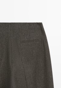 Dark gray tailored wool trousers showing back waistband and single welt pocket on white background.
