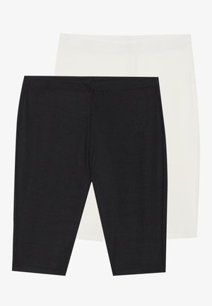 To par med tights: en i ribbestrikket svart stoff, den andre i glatt hvitt. Begge har elastisk midje og sømløst design.